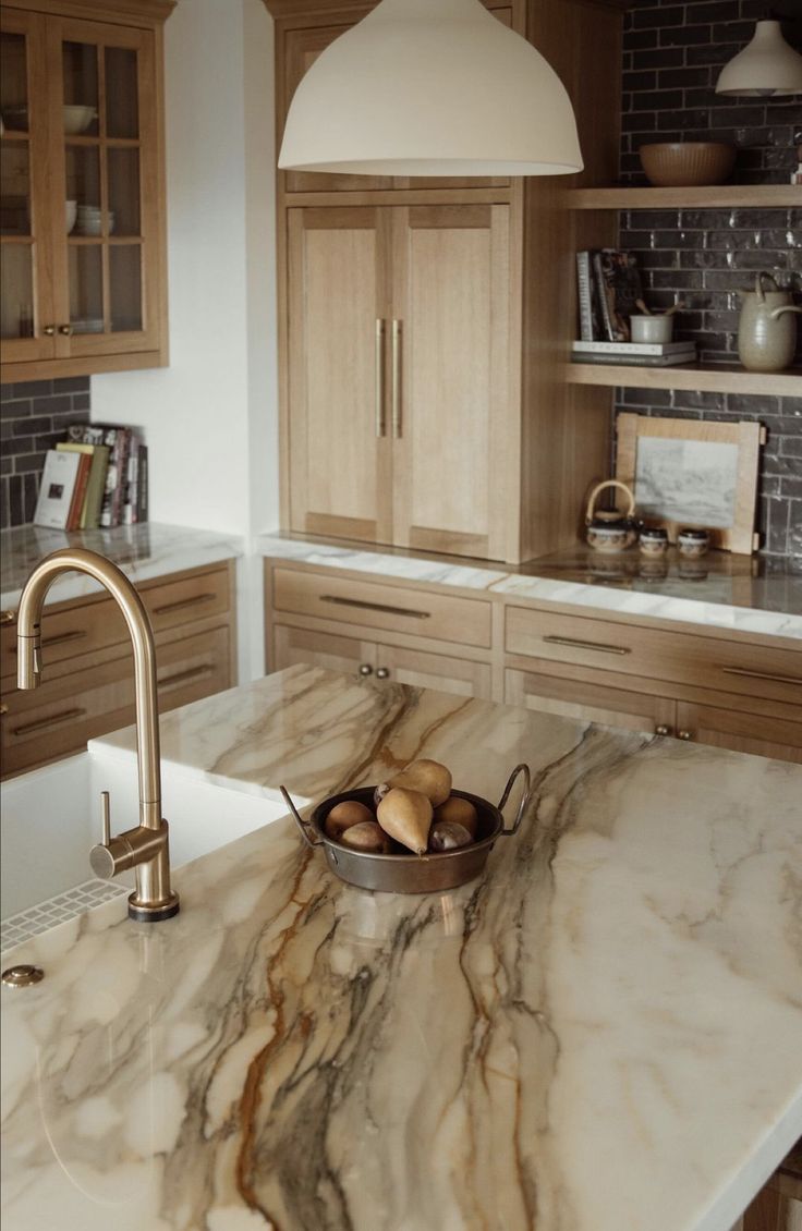 a kitchen with marble counter tops and wooden cabinets