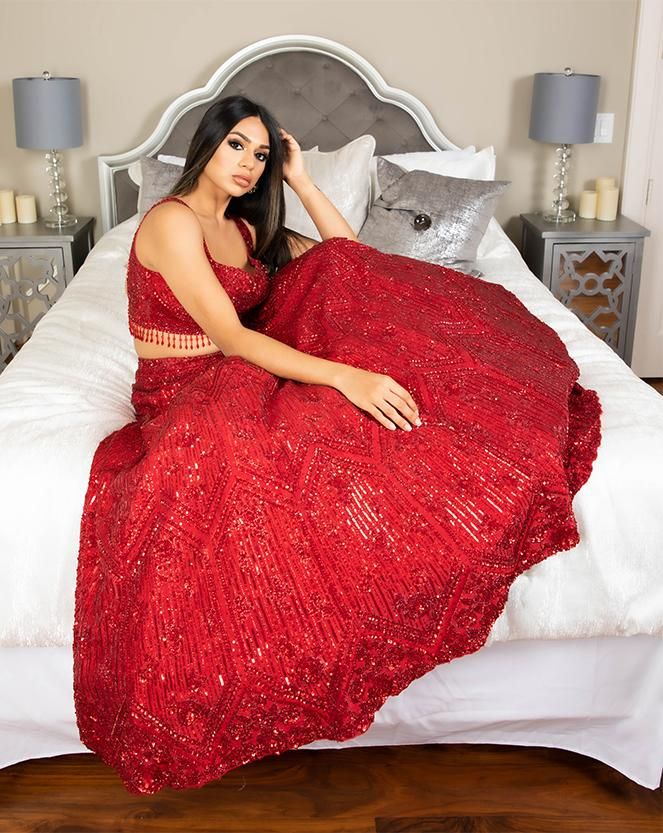 Our Merlot lehenga is the perfect blend of traditional and modern styles. This showstopper features a red-on-red skirt and bustier crafted with red sequin, diamonds, and beads. DELIVERY TIMEPlease allow 8-12 weeks for your outfit to arrive. FABRIC DETAILSRaw Silk, Organza.Professional cleaning only. Festive Embellished Wedding Skirt, Glamorous Sequined Wedding Skirt, Elegant Red Lehenga With Sequins, Red Sharara With Mirror Work For Party, Red Evening Gown With Resham Embroidery, Festive Red Sequined Sharara, Festive Sequin Fabric For Prom, Festive Embellished Party Skirt, Bollywood Style Red Hand Embellished Sharara