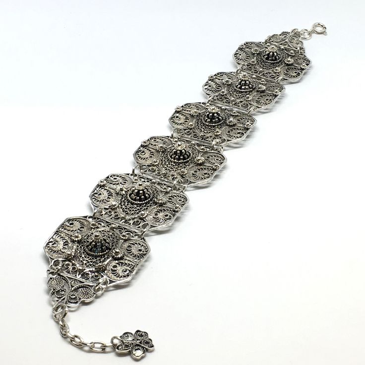 This bracelet is part of our Premium Master Collection. The bracelet was made by one of our family's master jewelers.  The entire bracelet is hand made with filigree techniques used by old filigree masters. The material used is sterling silver (925) and fine sliver (999). Creating this particular bracelet required patience, extensive work, creativity and it is one of the unique pieces amongst all of our collections. This bracelet reminds us of endurance, patience and delicateness. Bracelet Lengt Antique Sterling Silver Adjustable Bracelet, Elegant Adjustable Filigree Jewelry, Silver Oxidized Wedding Bracelets, Silver Bracelets With Oxidized Finish For Weddings, Adjustable Filigree Bracelets For Wedding, Silver Wedding Bracelets With Oxidized Finish, Sterling Silver Bangle With Intricate Design, Wedding Filigree Adjustable Bracelets, Ornate Metal Bangle Jewelry