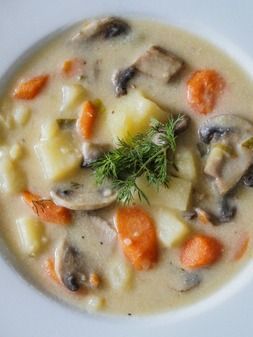 a white bowl filled with soup and vegetables