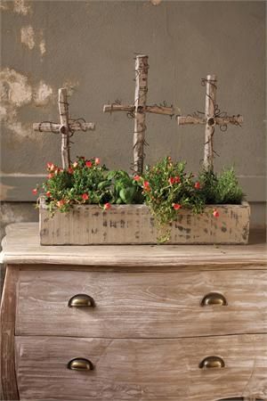 an old dresser with flowers and crosses on it