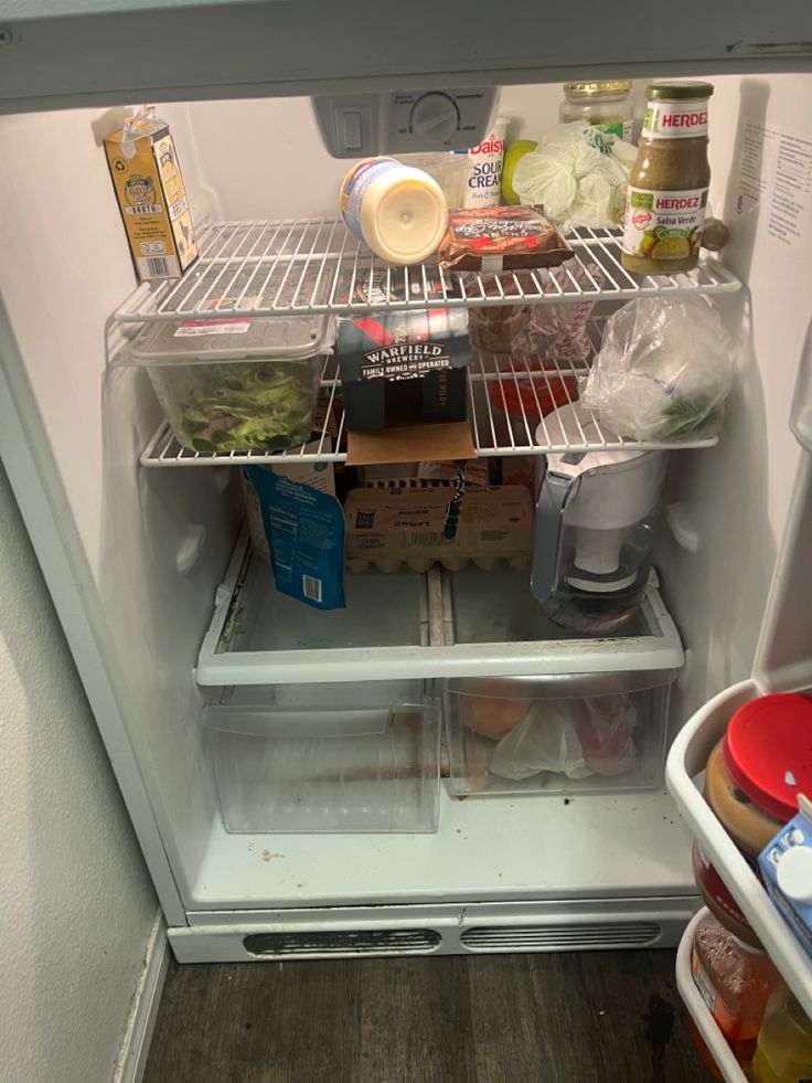 an open refrigerator filled with food and condiments