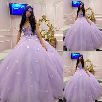 a woman in a purple ball gown posing for the camera