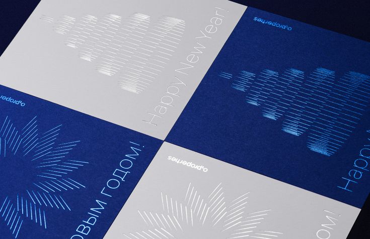 three brochures with blue and white designs on them