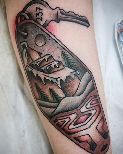 a tattoo with a bottle and key on it