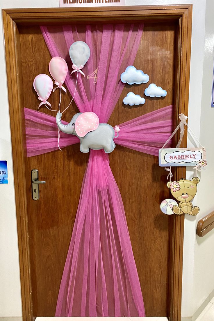 a door decorated with pink and white balloons