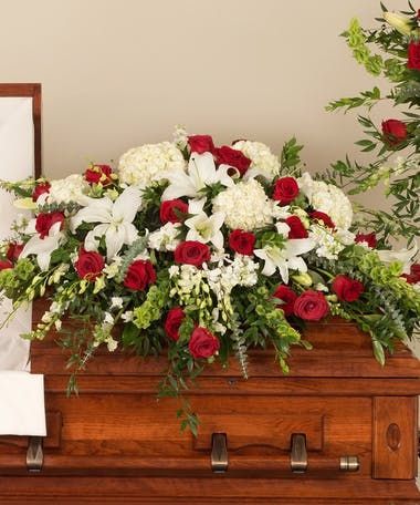 a casket with red and white flowers on it