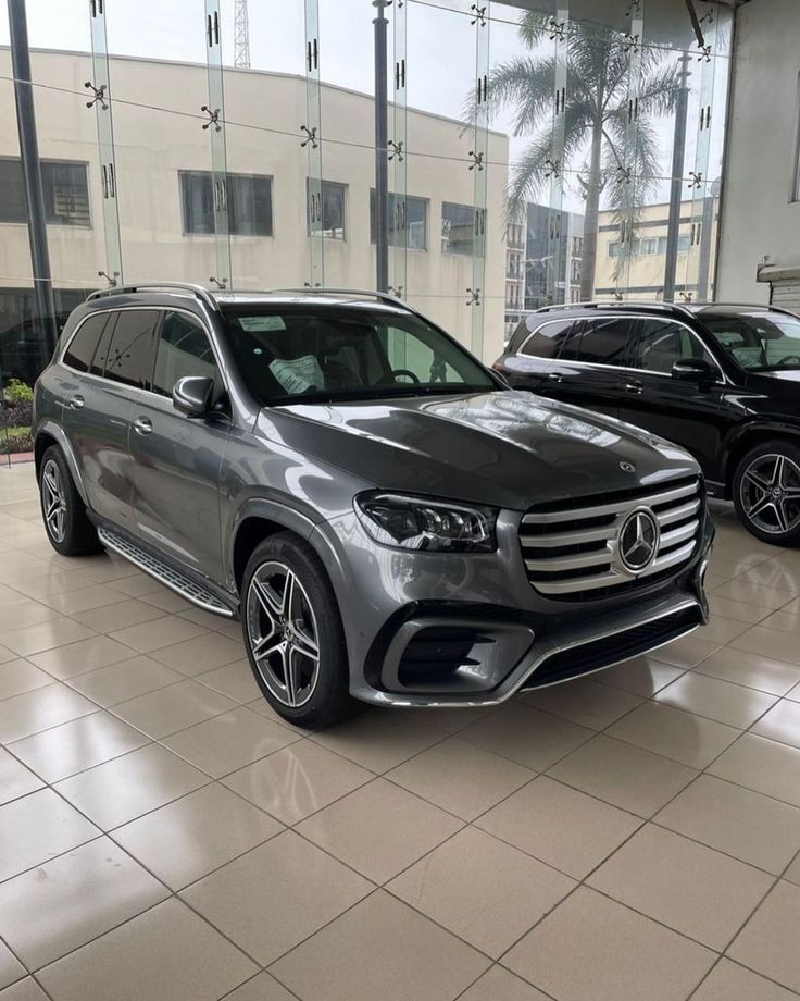 two mercedes benz vehicles in a showroom