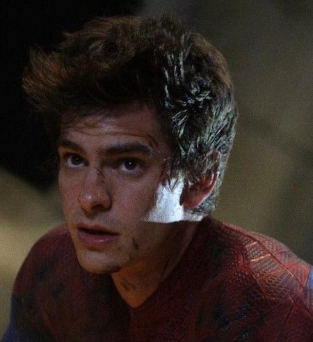 the amazing spider - man is looking at something in front of him with an intense look on his face