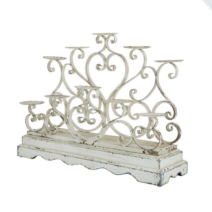 an ornate white candle holder with three candles