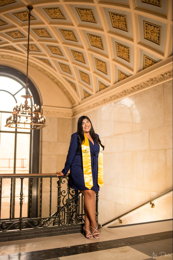 a woman is standing on the stairs in a building