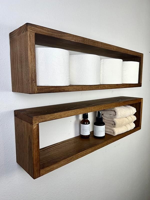 two wooden shelves with towels and bottles on them