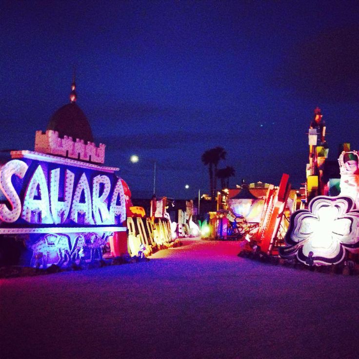 the sign is lit up with colorful lights