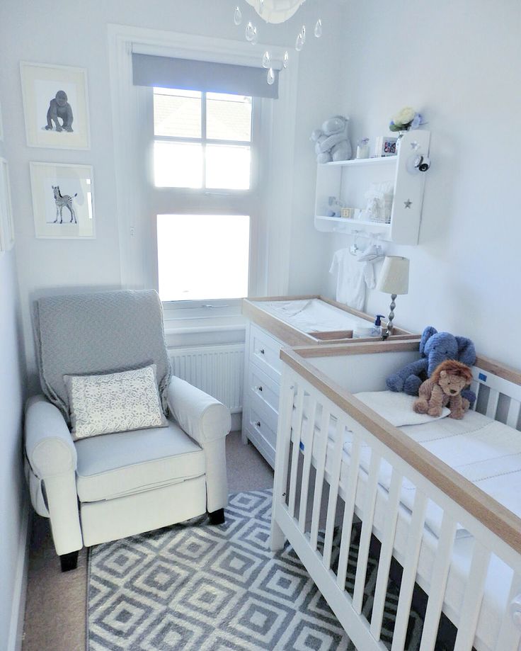 a baby's room with a crib, rocking chair, and nursery furniture