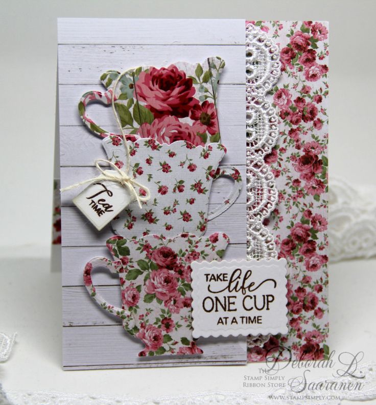 a close up of a card with flowers on it and a lace doily around the edge