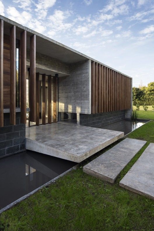 an exterior view of a modern house with steps leading to the front door and side entrance