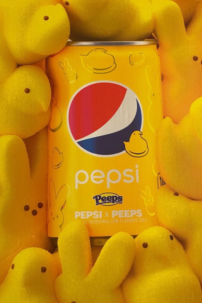 a can of pepsi is surrounded by peeps in the shape of little yellow chicks