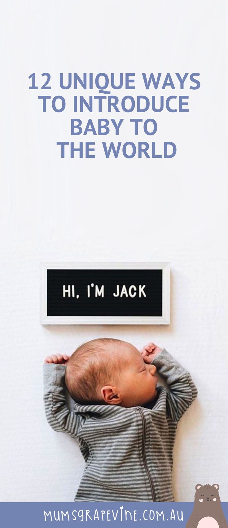 a baby laying on top of a white wall next to a sign