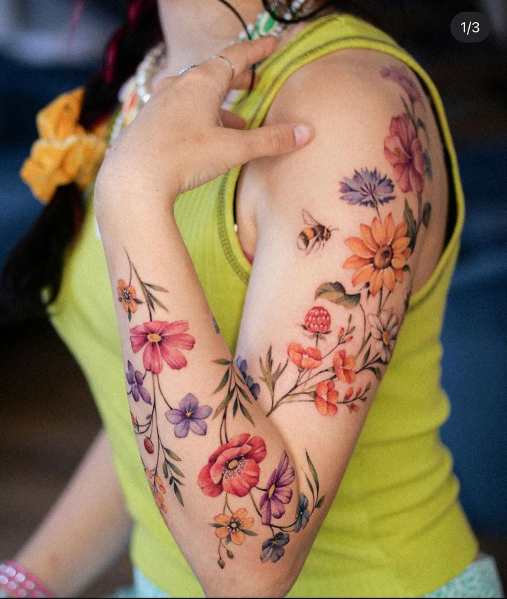 a woman with tattoos on her arms and shoulder