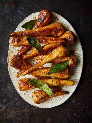 chicken wings on a white plate with green peppers and spices in the middle, ready to be served