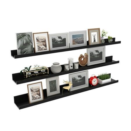 two black shelves with pictures and other items on them