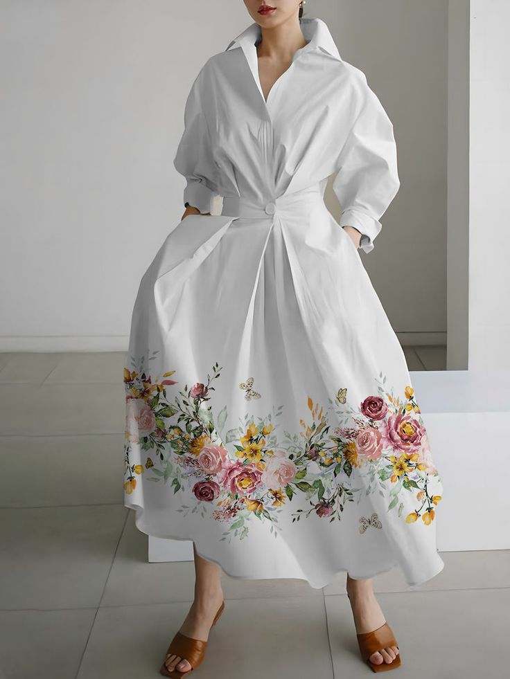 The White Floral Printed Long Casual Shirt Dress is a stylish and comfortable wardrobe staple, featuring delicate floral patterns that exude elegance. Its long, flowing silhouette and soft fabric make it perfect for casual outings or relaxed gatherings. This versatile piece effortlessly combines fashion and ease for a chic, everyday look. Spring Printed Button-up Dresses, Modest Floral Dress For Spring, Chic Floral Embroidery Dress For Spring, Chic Spring Floral Dress With Embroidery, Chic Spring Floral Embroidered Dress, Spring A-line Shirt Dress, Chic Floral Embroidered Dress For Spring, Casual V-neck Floral Print Shirt Dress, Casual Collared Spring Dresses