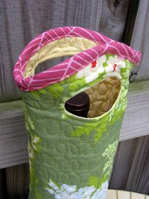 a green and pink bag sitting on top of a white table next to a wooden fence