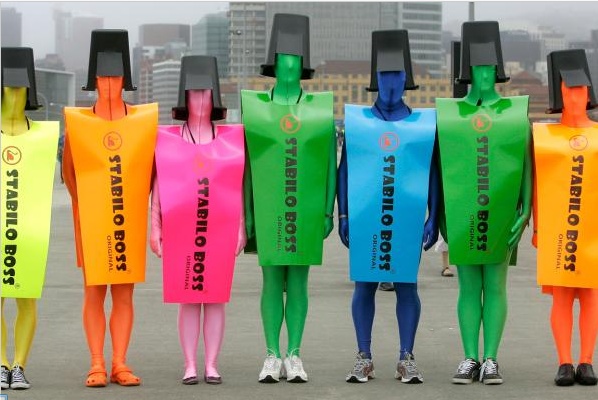 five people in colorful plastic bags standing next to each other