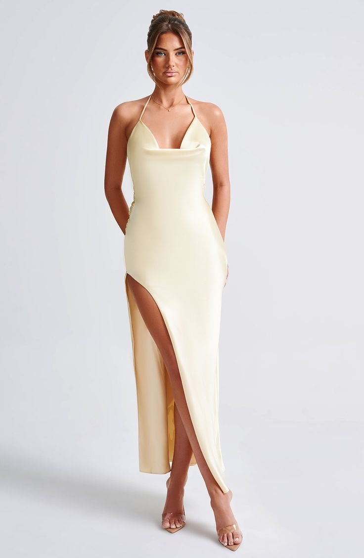 With her cowl neckline and even lower dropped back, Kiandra is the perfect design for formal dinners that turn to late night afterparties. Cut from a luxe non-stretch satin which skims over the figure, a low, exposed back and thigh high split add drama. Finish the look with a pair of statement earrings and a glossy lip, and you'll be turning heads the whole night.Â 



Colour: Lemon.

Premium non-stretch satin.

Fully lined.

Cowl, halter neckline.

Low scoop back.

Ties to the reverse to create Backless Satin Finish Evening Dress, Fitted Backless Dress With Side Slits For Formal Occasions, Fitted Backless Dress With Side Slits For Formal Events, Cowl Neck Satin Dress For Parties, Satin Cowl Back Dress With Satin Finish, Party Slip Dress With Satin Finish And Cowl Neck, Elegant Draped Satin Slip Dress, Bias Cut Satin Backless Dress For Gala, Sleek Backless Dress With Cowl Back For Night Out