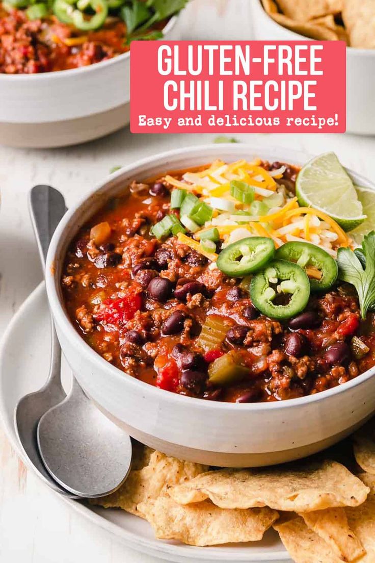 a white bowl filled with chili and tortilla chips on top of a plate