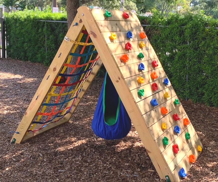 a child's play area with a climbing frame and colorful balls