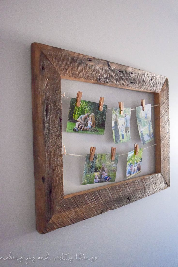 a wooden frame with pictures hanging on clothes pins