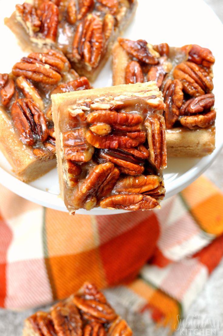 pecan pie bars on a white plate