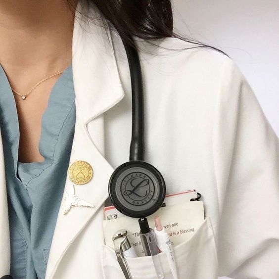 a woman wearing a white coat with a stethoscope attached to her pocket