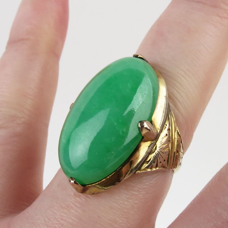 A superb 20 carat natural green Jadeite stone is featured on this vintage 14k yellow gold ring. This ring comes with an official Mason Kay certificate, which is the gold standard of jade authentication and costs over $ 100.00 to obtain. It concludes and certifies that the green jadeite is natural Type A and has NOT been dyed or treated. Mason Kay also did a value assessment report earlier this year stating that the retail replacement value for the jade alone would be $8,125.00. The oval 14.6mm x 24.05mm x 7.06mm jade cabochon is a wonderful saturated apple green hue with natural variations in color and translucency. The luscious gem is large, smoothly polished and won't go unnoticed. Four large prongs hold the precious gem above an enclosed gallery with small oval opening on back. The Art Heirloom Green Emerald Oval Cabochon Ring, Heirloom Green Oval Cabochon Emerald Ring, Collectible Green Emerald Ring In 14k Gold, Collectible 14k Gold Emerald Ring, Green 14k Gold Emerald Ring Collectible, Green Oval Cabochon 14k Stamped Jewelry, Vintage Oval Turquoise Ring For Formal Events, Vintage Oval Turquoise Ring For Formal Occasions, Green Cabochon Rings In Art Deco Style