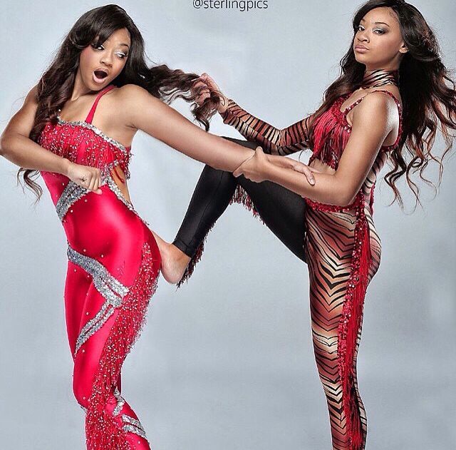 two beautiful women in red and black outfits