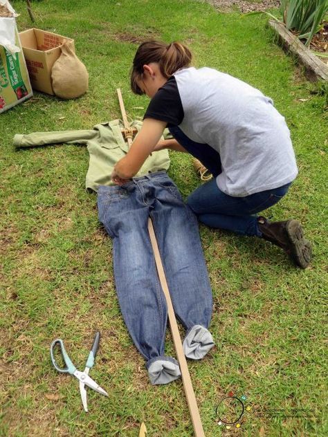 a woman kneeling down on the grass with tools