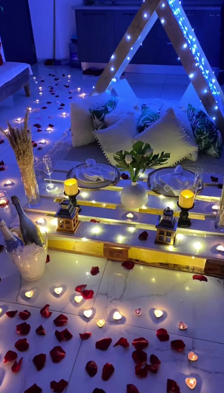 a room with candles and flowers on the floor