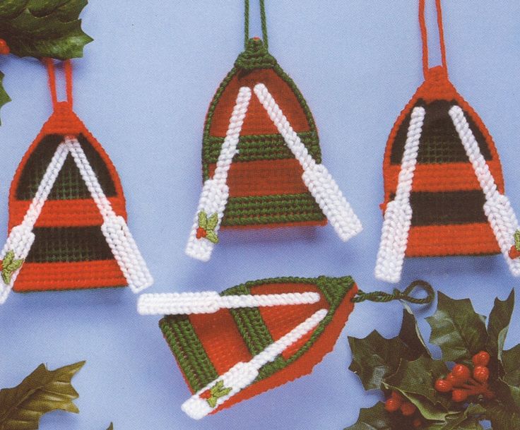 three christmas ornaments are hanging on a blue background with holly and berries around the decorations