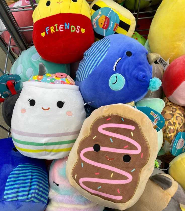 a pile of stuffed animals sitting next to each other on top of a shopping cart