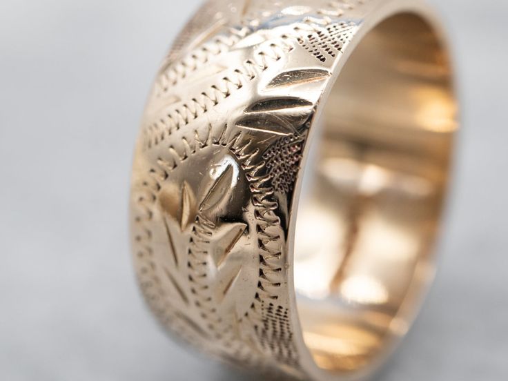 So many wonderful details come together to give this vintage band a rich, textural feel! Crafted of 14 karat yellow gold, this is a great band for stacking or wearing traditional as a wedding band!Metal: 14K Yellow GoldWidth of Band: 8.0 mmHeight off Finger: 1.4 mmRing Size: 6Marks: “<14K>” Stamped on the inside band Formal 14k Gold Engraved Ring With Decorative Band, Elegant 14k Gold Bands With Intricate Design, Yellow Gold Jewelry With Decorative Thick Band, Yellow Gold Etched Bands For Anniversary, Yellow Gold Jewelry With Decorative Open Band, Etched Yellow Gold Bands For Anniversary, Yellow Gold Open Band Jewelry With Decorative Band, Yellow Gold Bands With Intricate Design In 14k, 14k Yellow Gold Bands With Intricate Design