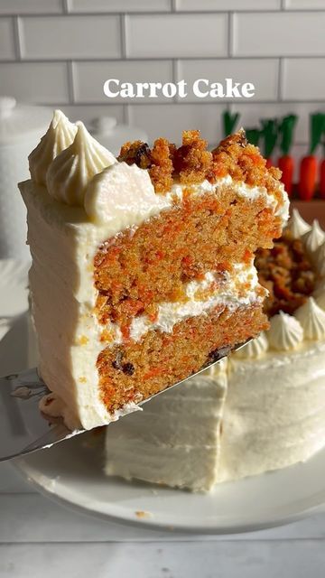 a carrot cake with white frosting on a plate