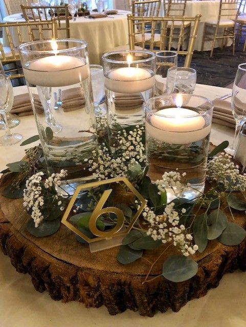 the centerpiece is decorated with candles and greenery