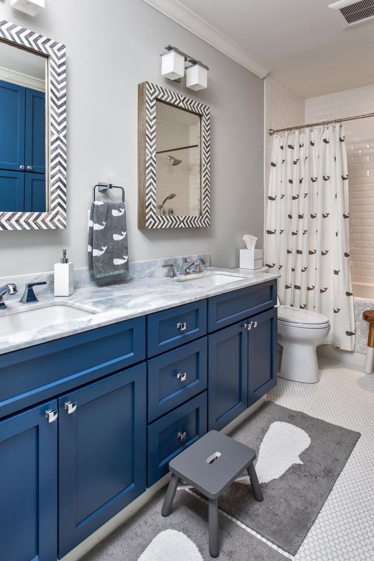 a bathroom with blue cabinets and white fixtures