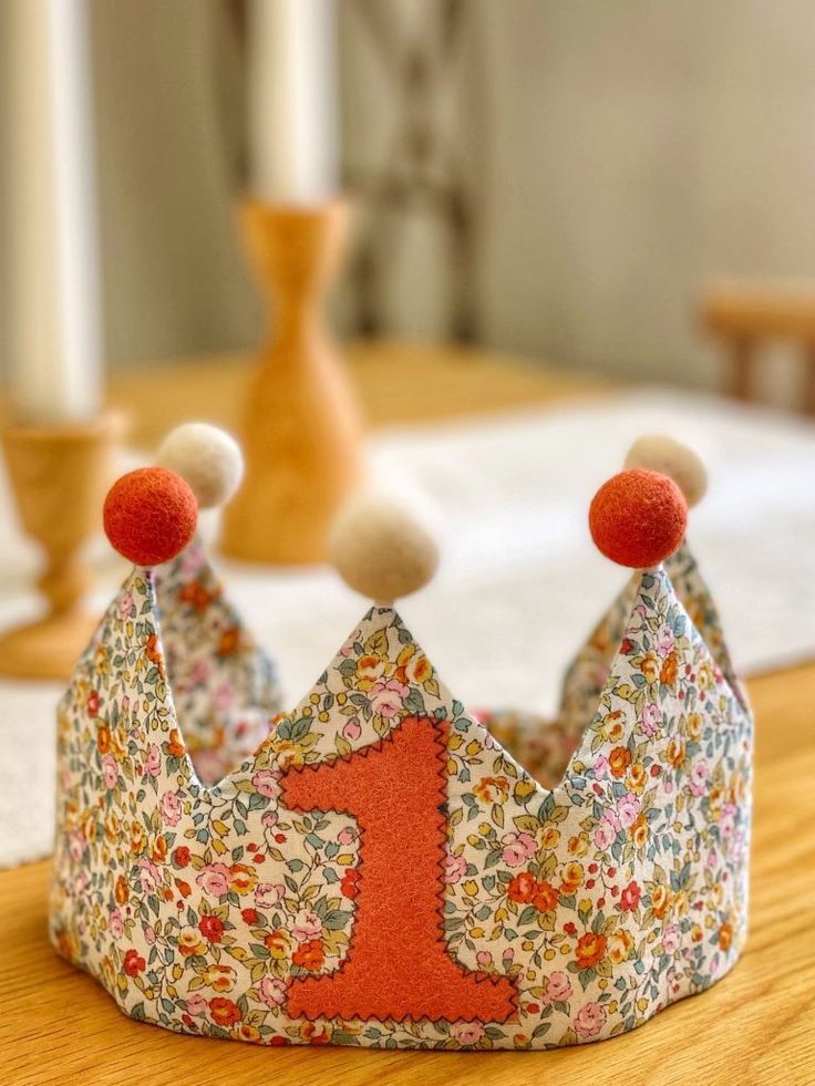 a little crown sitting on top of a wooden table