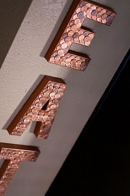 the letters are made out of coins and have been placed on top of each other