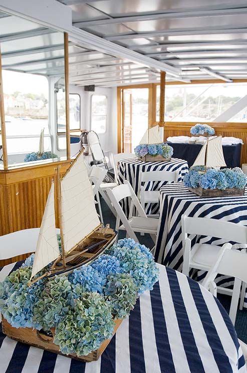 there is a boat with blue flowers on the table