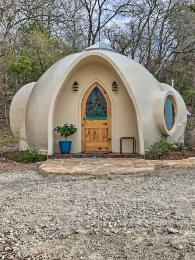 an unusual looking building with a wooden door