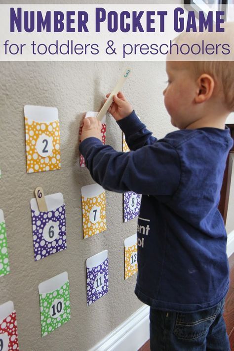 a young boy is playing with a number pocket game for toddlers and preschoolers