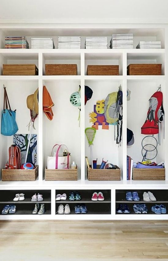 an organized closet with shoes, bags and purses on the shelves in front of it